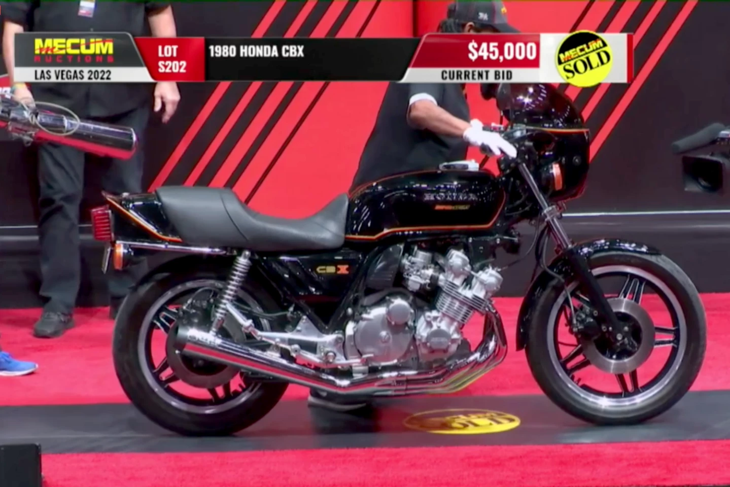 This 1980 Honda CBX sold for $49,500 (the $45,000 that can be seen on this screen grab from the auction, plus 10 percent buyers fee) as Lot S202 at Mecum Auctions' Las Vegas sale on Saturday, 29 January 2022. The original exhaust selling with the bike (see left of image of Mecum employee carrying the extremely costly original exhaust helped propel the bike to a new world record price for the CBX.