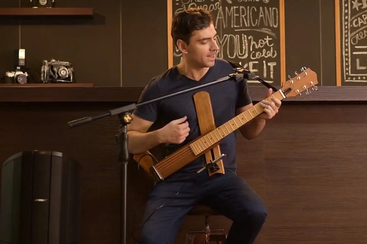 The folding Cross Guitar 2.0 has a built-in headphone amp that can be output to powered speakers