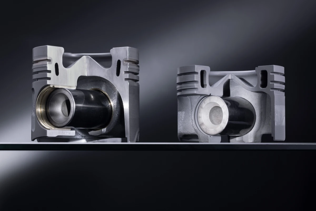 An aluminum piston (left) and one of the new steel pistons (right)