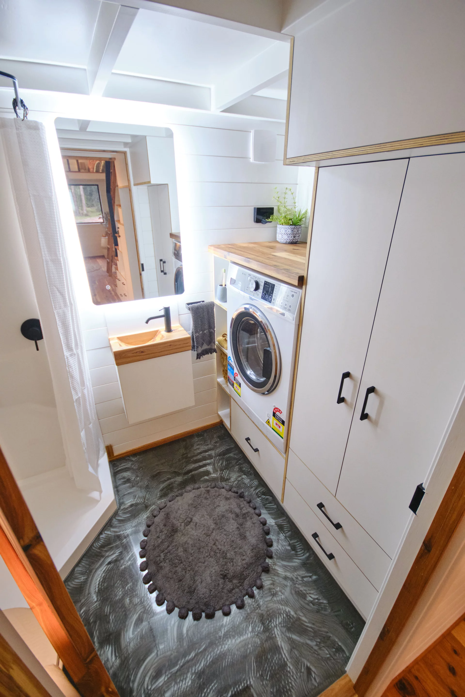 The Grand Sojourner Layout 3's bathroom includes a washer/dryer and some storage space