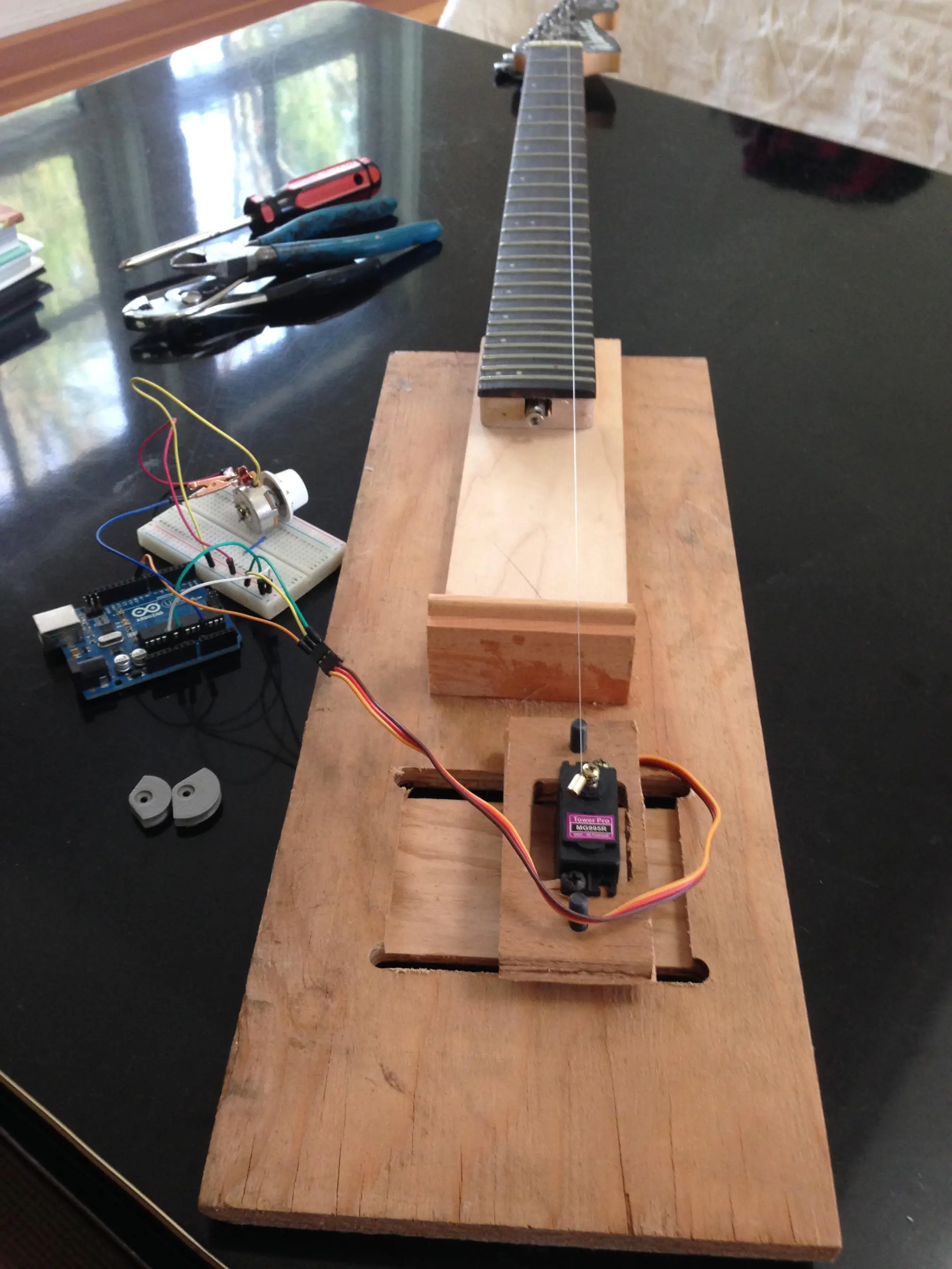 The first test model, with a single string, analog servo, Arduino and breadboard