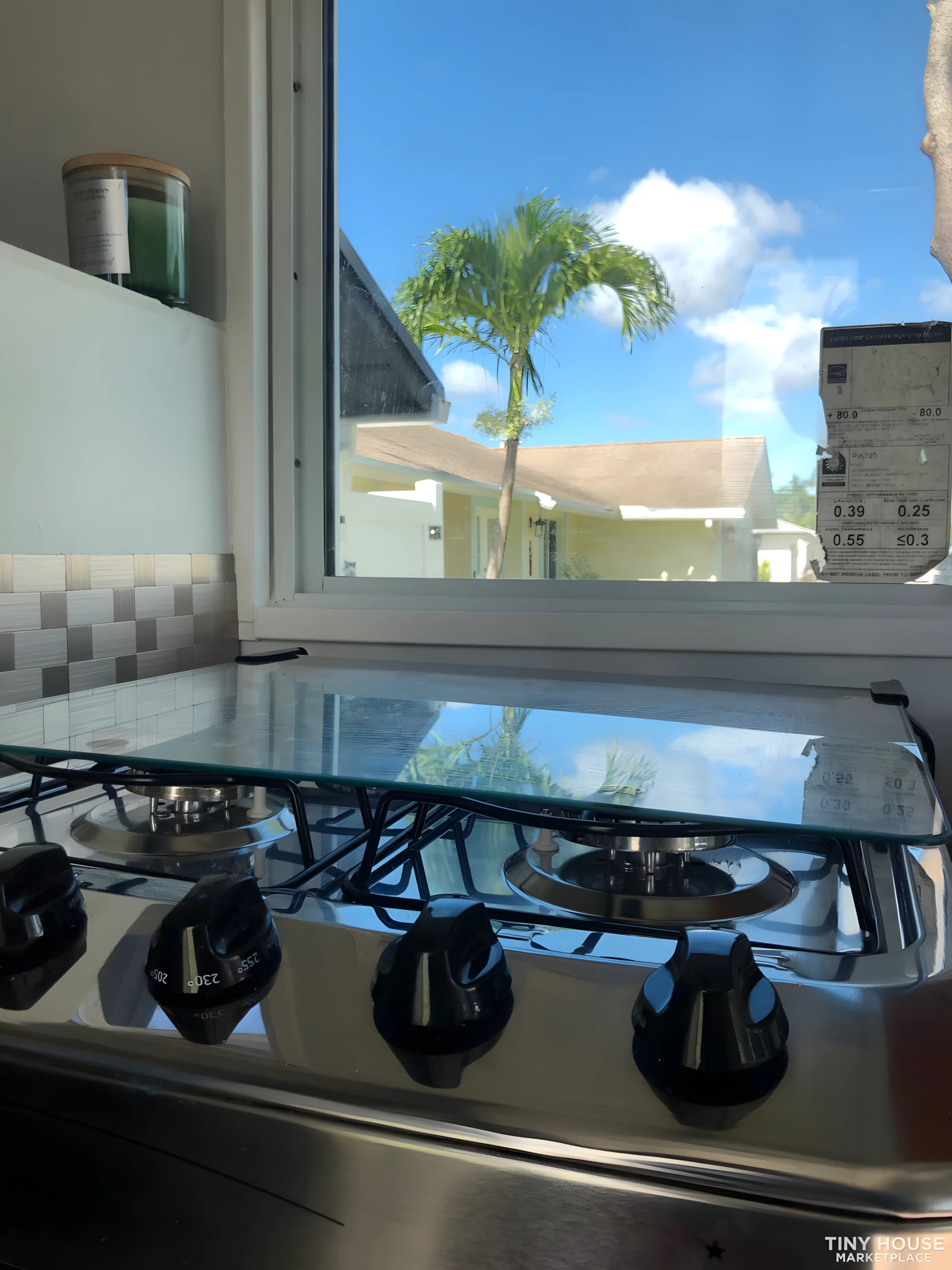 The Nano Micro House's kitchen includes a four-burner propane-powered stove and an oven