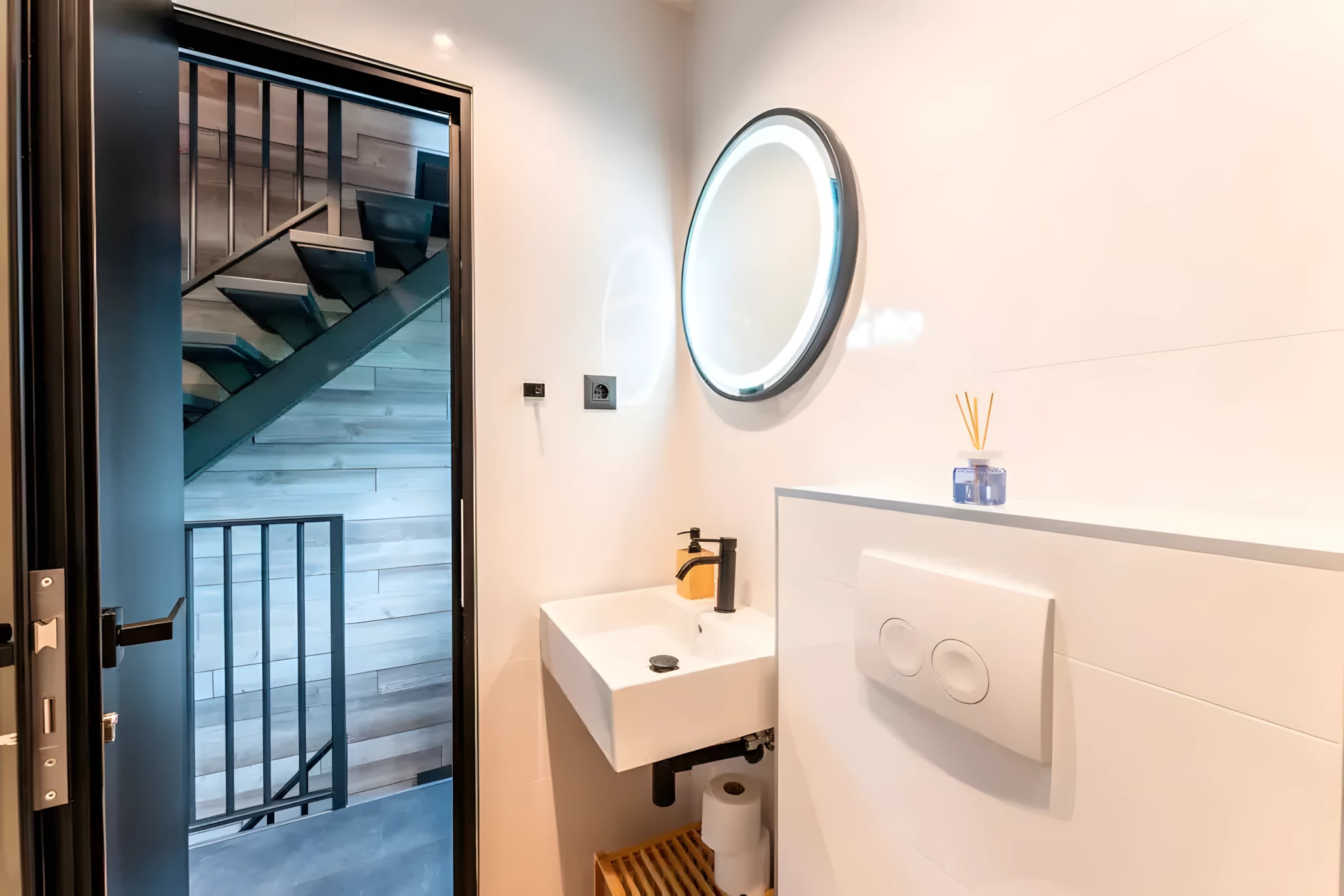 The DQ Tower's main bathroom is located on the second floor and has a shower, vanity sink, and a flushing toilet