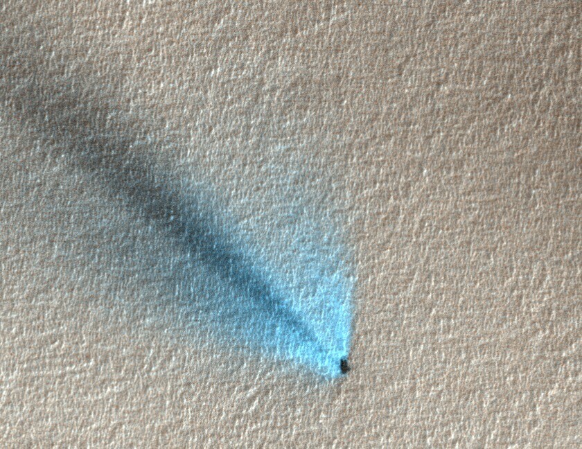 An unusual fan, light rather than dark, thought to be caused by carbon dioxide gas escaping from under the ice recondensing into frost