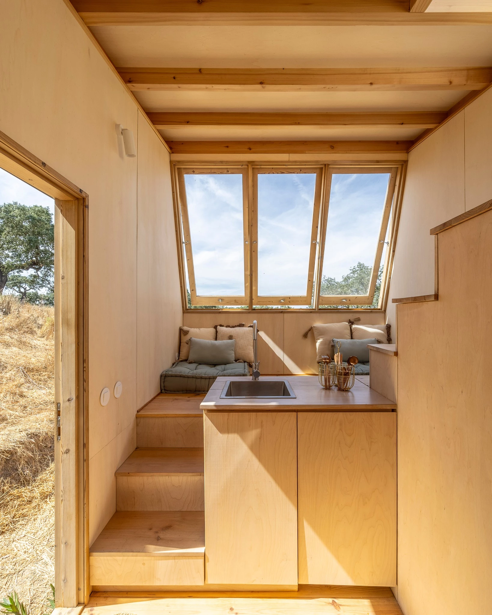 The Terra m2_Tiny House on Wheels' kitchen is small and simple and contains a sink and cabinetry
