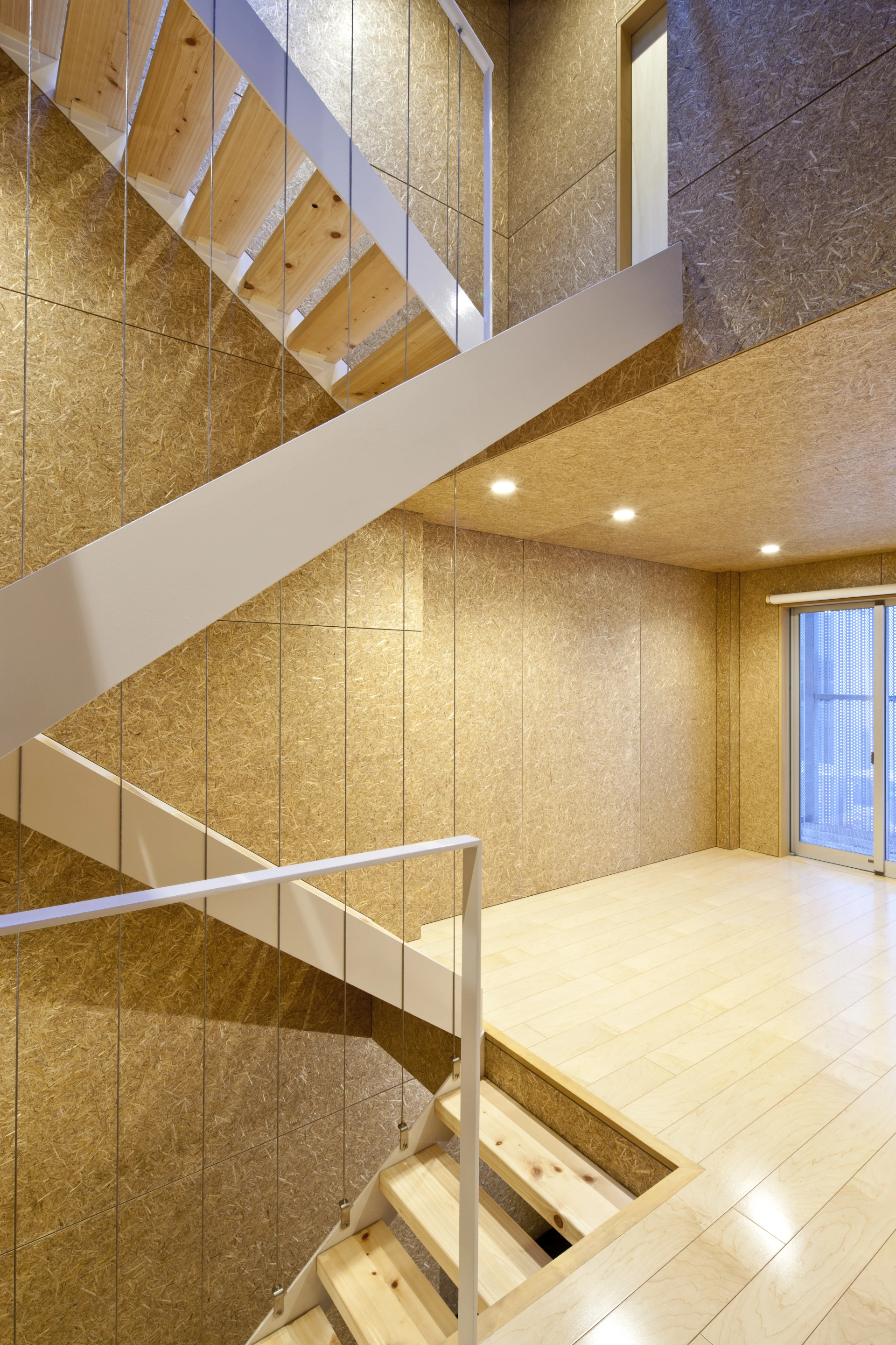 The building's internal walls and ceilings are made from oriented strand board (OSB) panels and hardwood flooring features throughout (Photo: Stirling Elmendorf)