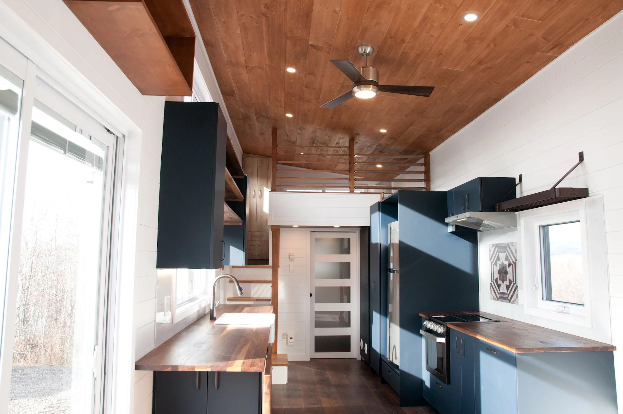 The Charme V2's kitchen area is cooled by a ceiling fan. A mini-split air-conditioning unit and propane-powered heating are also installed to help keep the interior a comfortable temperature
