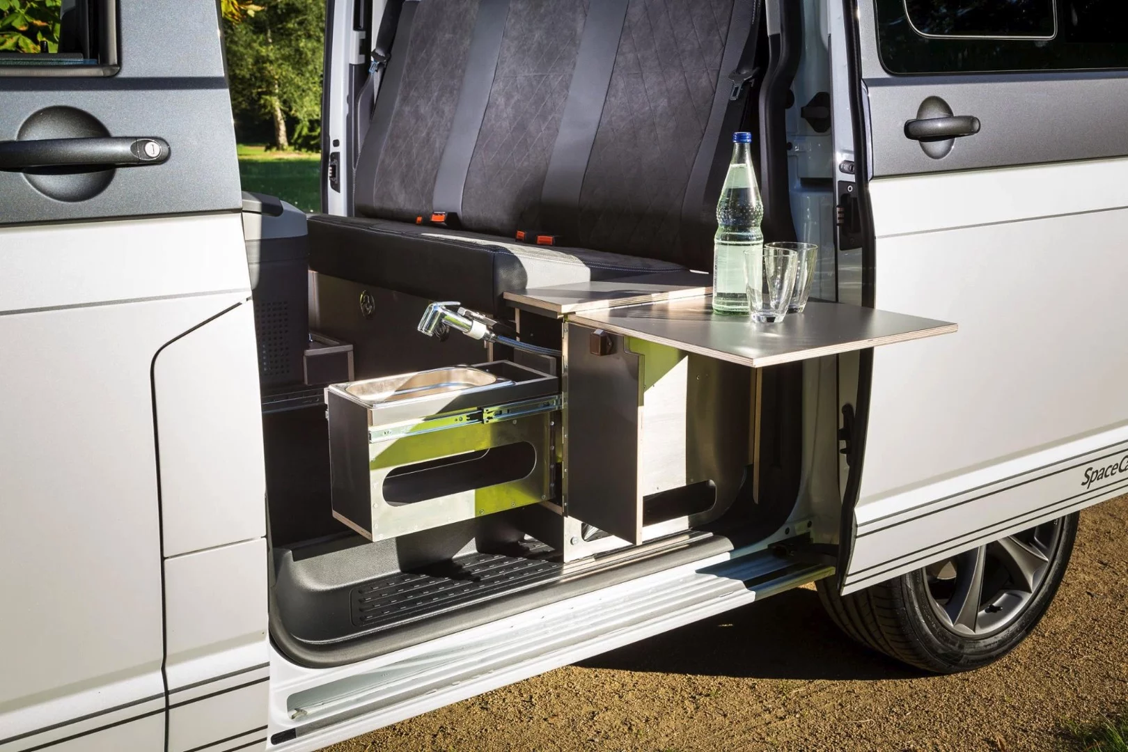 The driver-side rear console houses a sink and flip-out table