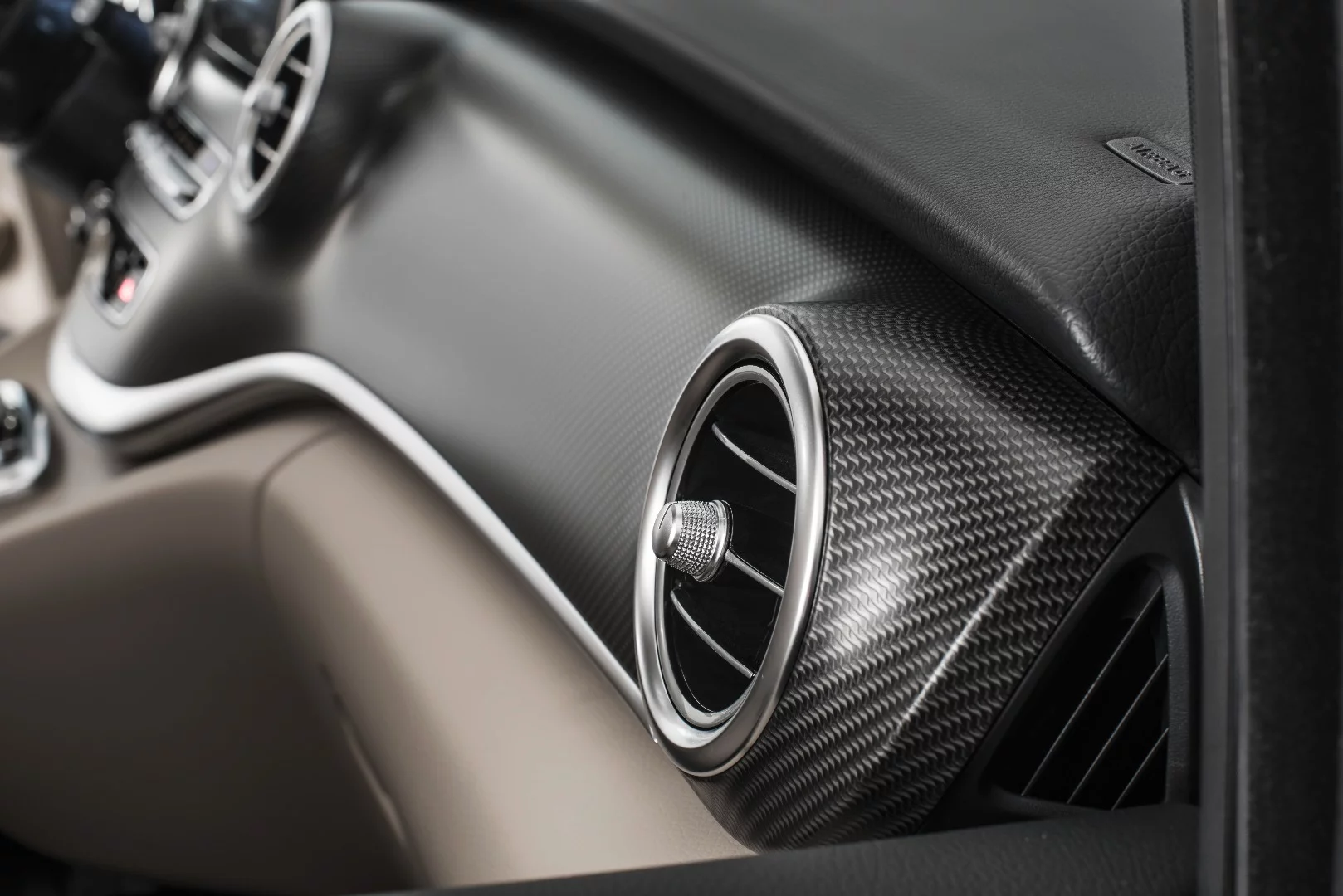 Carbon fiber-look trim and silver chrome vents inside the AMG Line