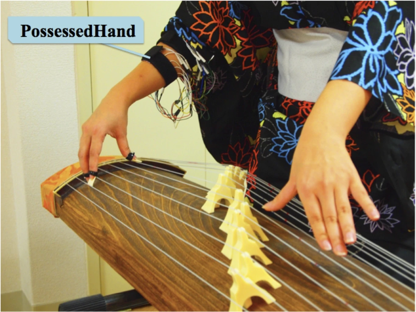 The PossessedHand system uses non-invasive electrical stimulation of muscles in the forearm to control movement of joints in the hand - helping fledgling Koto players learn faster (Photo: Emi Tamaki and Jun Rekimoto / University of Tokyo)