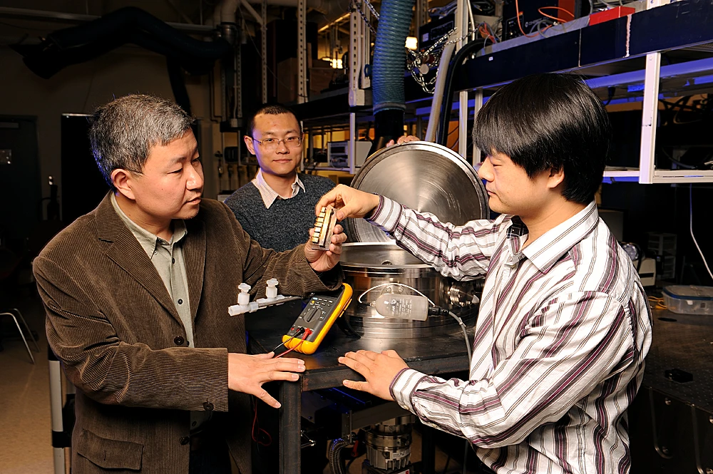 Xinwei Wang (left), with team members Guoqing Liu and Xiaopeng Huang, showing some of the equipment they used to measure the silk's thermal conductivity