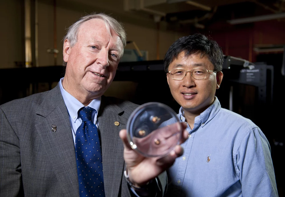 Edwin Thomas, left, and Jae-Hwang Lee holding a polymer material containing three bullets (Photo: Tommy LaVergne, Rice University)