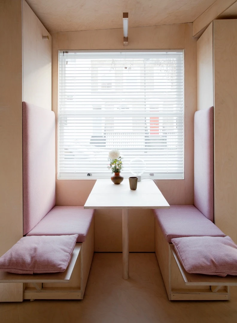 Shots showing the 13 sq Metre House's dining booth extending in length