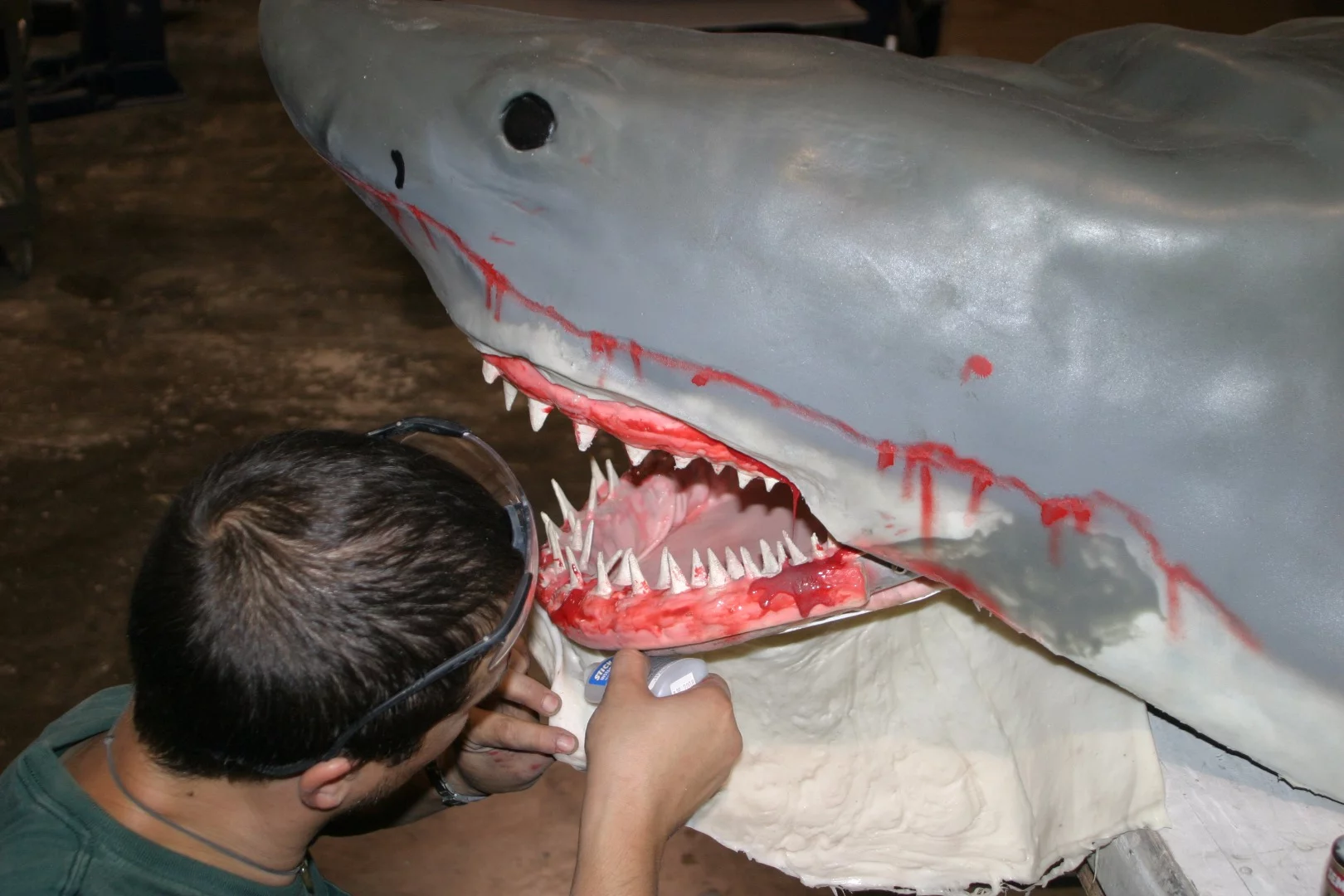 Eddie Paul's assistant attaches a chunk of rubbery skin to the lower jaw