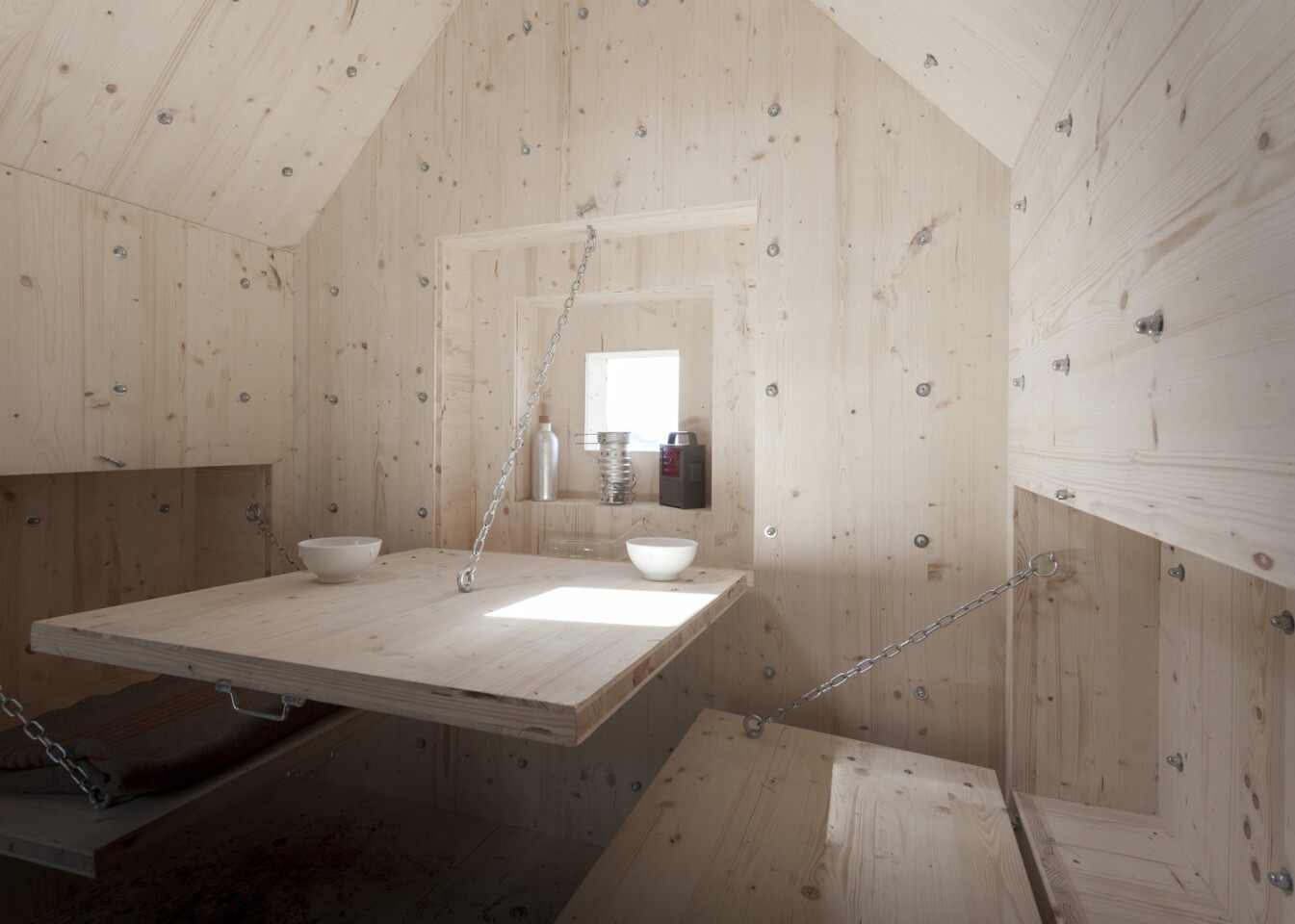 Fold-down furniture that reveals a table, bed, and seating (Photo: Dylan Perrenoud)