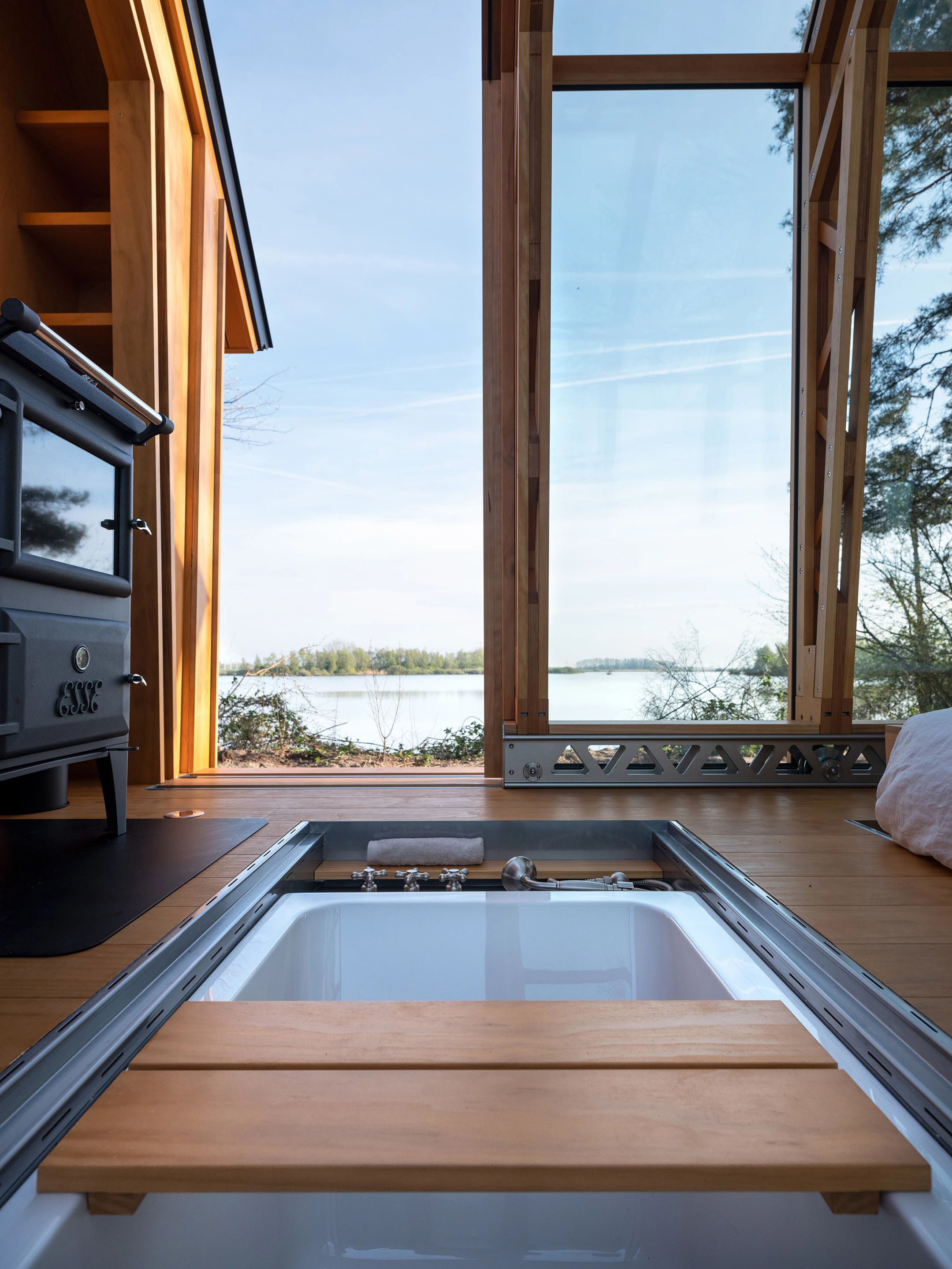 The ANNA Stay 2.0's bath is sunk into the floor, letting the owner bathe among nature, though there is also a more standard bathroom with a shower, toilet, and sink elsewhere in the home