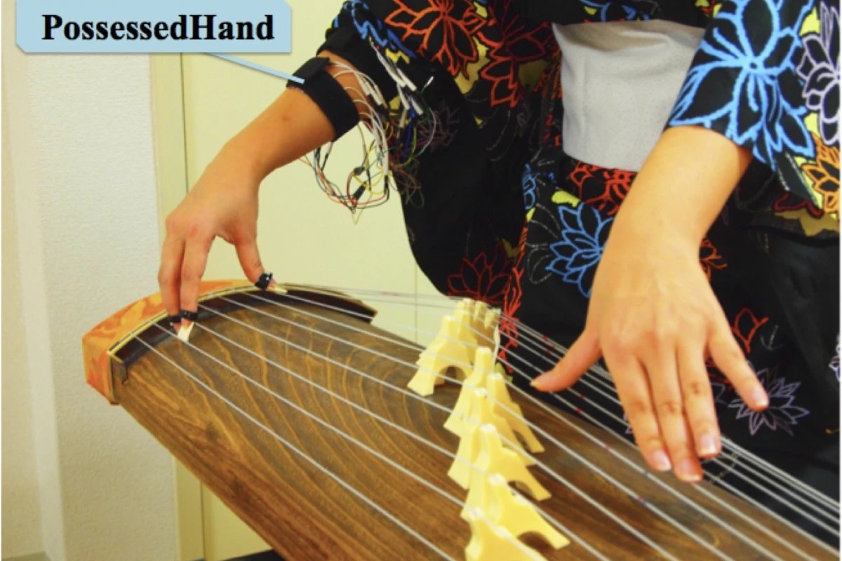 The PossessedHand system uses non-invasive electrical stimulation of muscles in the forearm to control movement of joints in the hand - helping fledgling Koto players learn faster (Photo: Emi Tamaki and Jun Rekimoto / University of Tokyo)