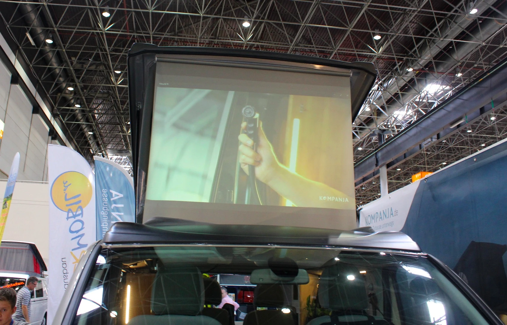 The movie screen can be viewed from both sides, so people inside and outside the van can watch at the same time