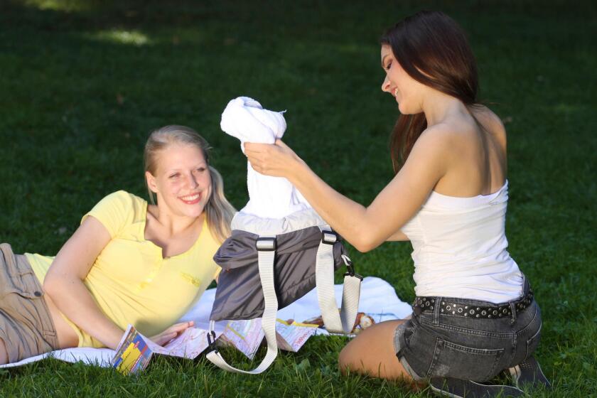 The towel pulls out from inside the backpack