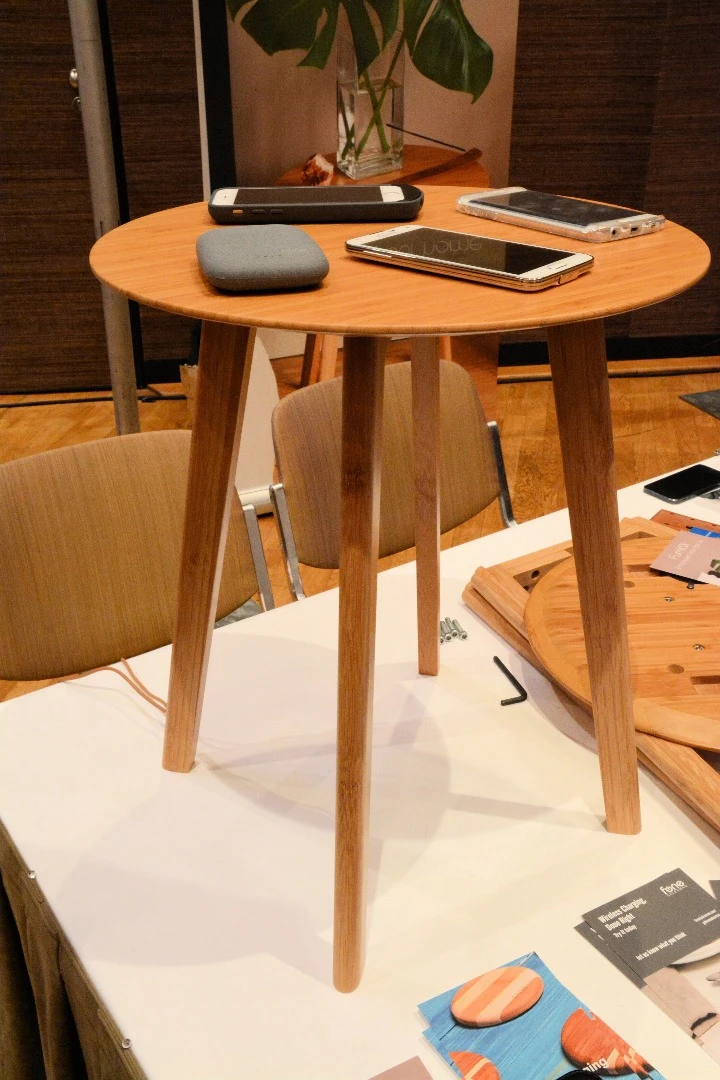 A fully-assembled FurniQi side table with Qi-compatible devices on top