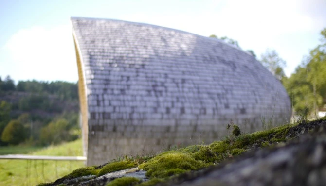 Protected from the elements, the exterior walls and roofing have a surface layer of biodegradable, cellulose-based, reinforced board which is wind and water resistant