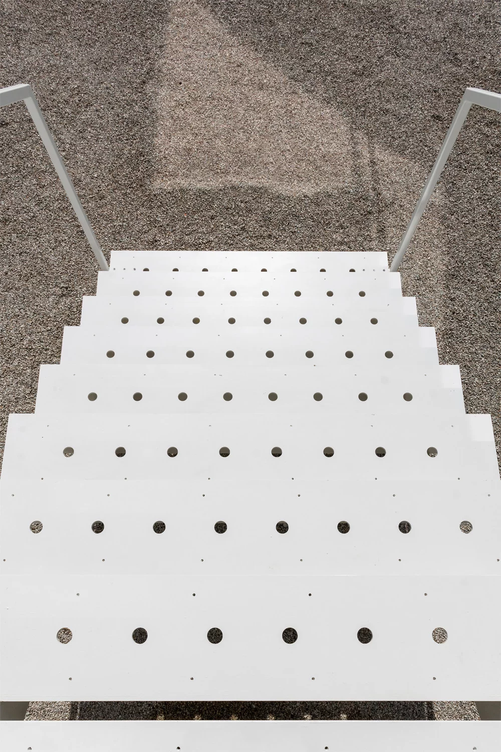 Steel staircases provide access to the home at both ends of the dwelling