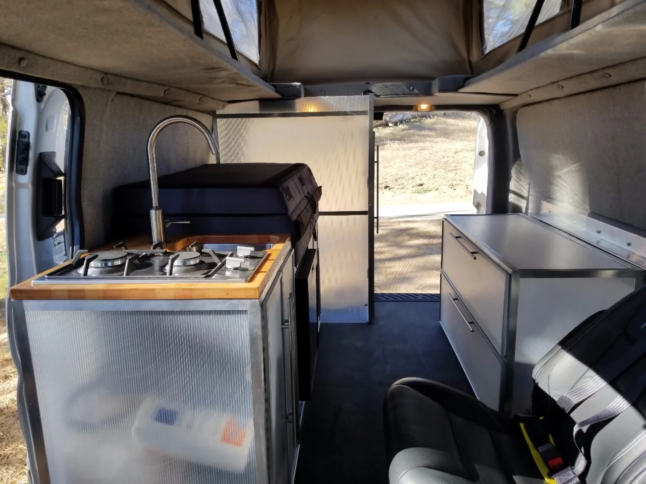 The passenger side includes the kitchen, storage cabinet and toilet room