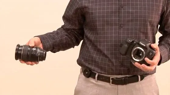 The Backer Capper (seen here mounted on a belt) is a product that's designed to make it easier for photographers to change lenses when they can't put their camera down