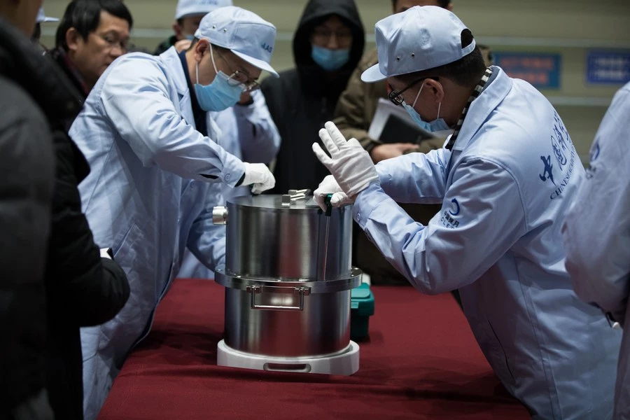Scientists transfer the container loaded with Moon samples retrieved by the Chang'E 5 probe in 2020