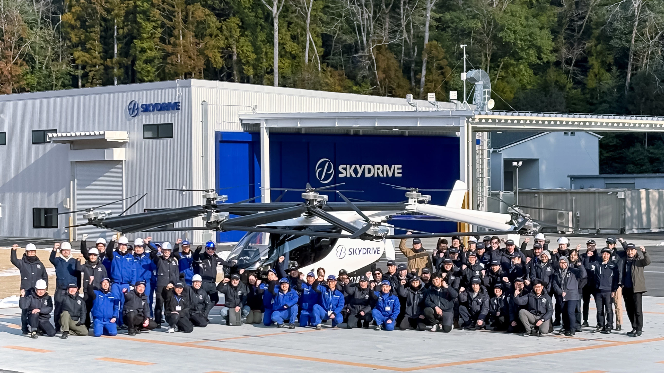 SkyDrive employees pose with the SkyDrive SD-05