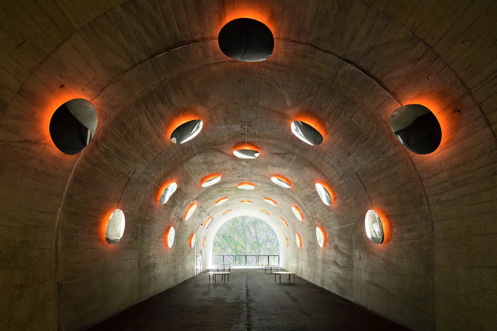 The "Fire" installation at the Kiyotsu Gorge Tunnel features convex mirrors that mimic molten blobs