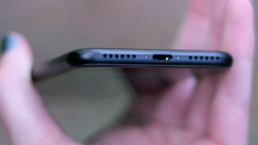 No headphone jack, just two symmetrical grilles on either side of the Lightning port