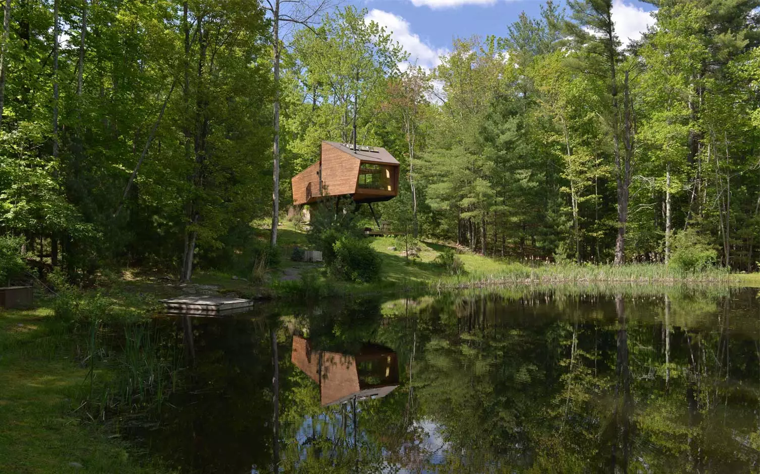 The Inhabit Treehouse hovers over a local lake just outside Woodstock