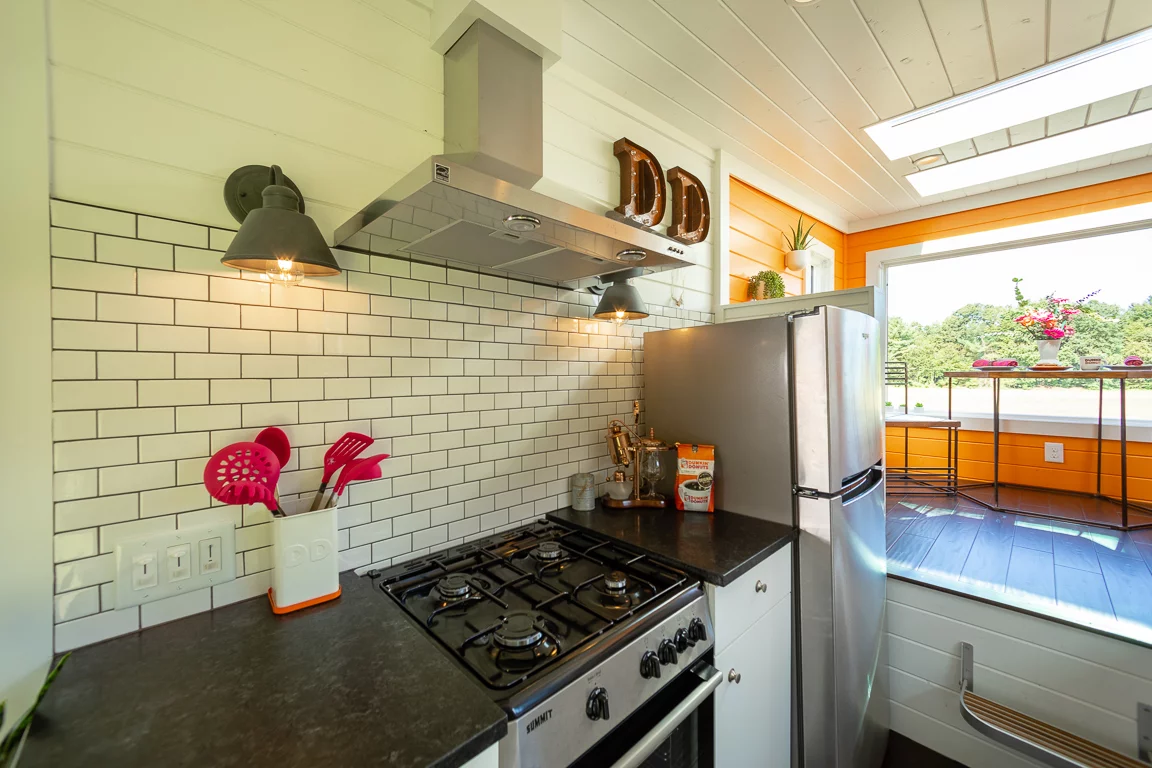 The Home That Runs on Dunkin's kitchen is large for a tiny house and includes full-size appliances