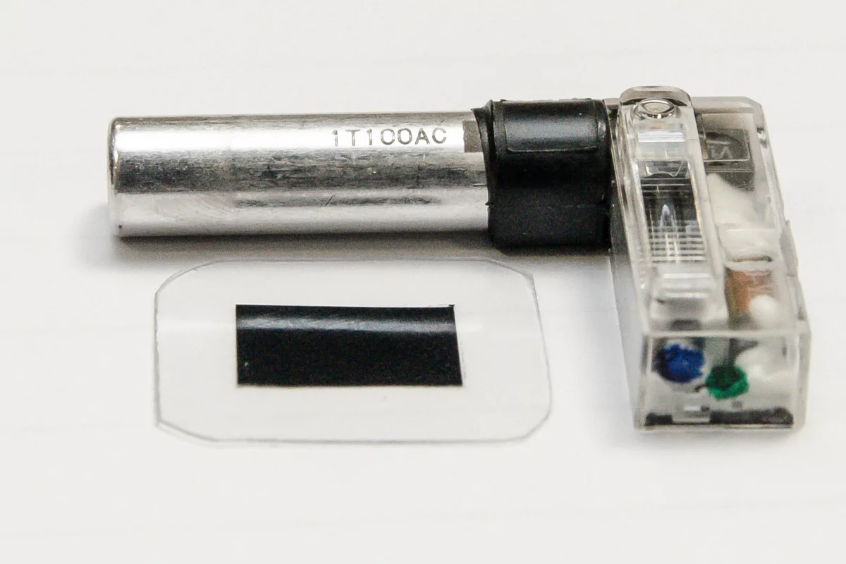 A typical smartphone flash with its existing capacitor (silver cylinder), and the new polymer capacitor material (lower left)