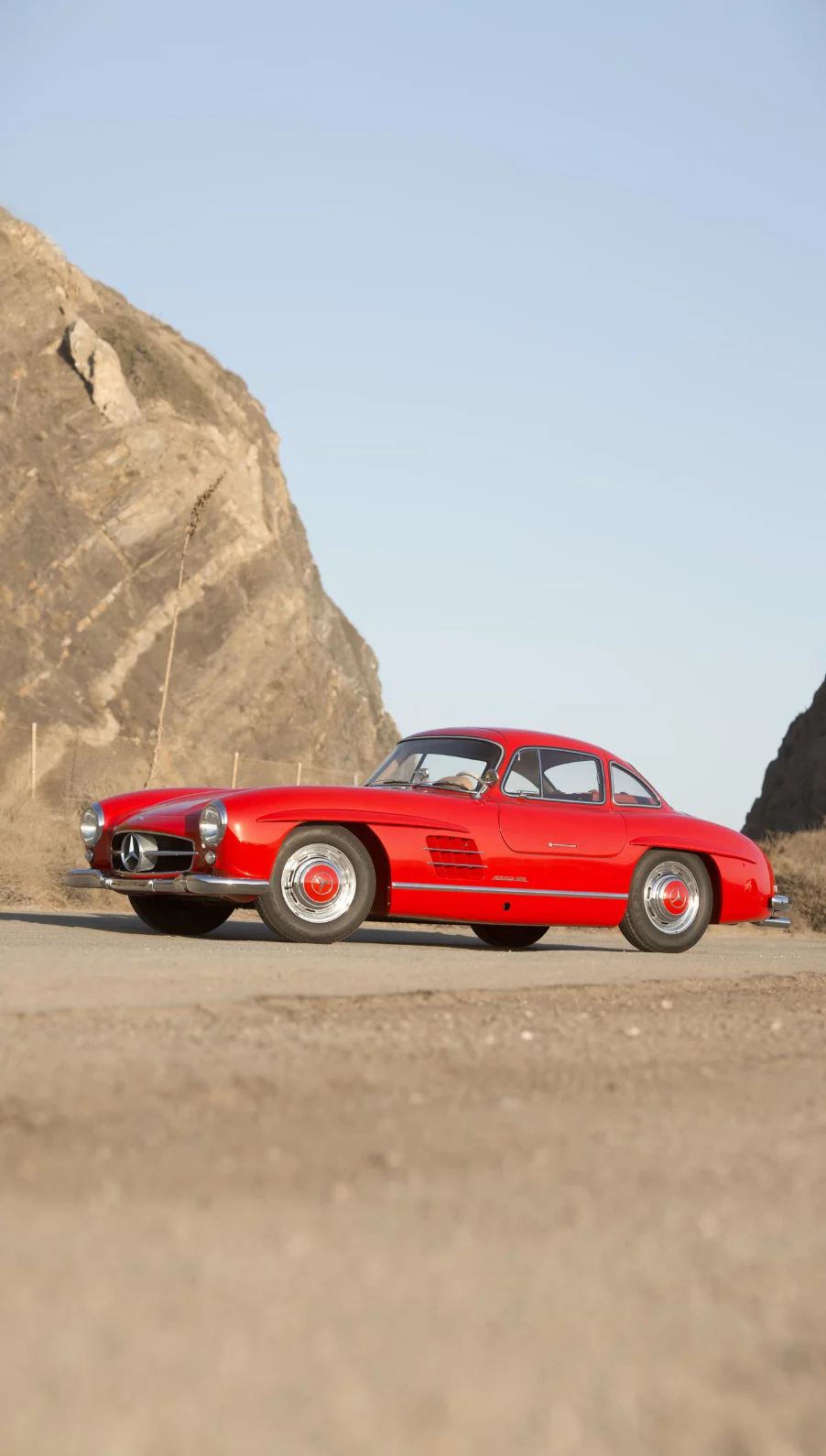 Instantly recognisable as the Mercedes-Benz 300SL (for Sports Leicht) Gullwing coupe, this 1955 model was built with DB 534 Feuerwehrrot (Fire Brigade Red) paintwork for its first owner, The Right Honourable Lord Terence O'Neill, Baron O'Neill of the Maine. At the end of 1945, Lord O'Neill and his family went to live in Northern Ireland, where he served in a series of political positions. Around the time he acquired the Gullwing, O'Neill was elevated to cabinet level, until his appointment as Prime Minister of Northern Ireland in 1963. Lord O'Neill remained in office until 1969. The entire history of the car and the model is detailed on the official auction page. The car was sold by Bonhams for US$1,375,000.
