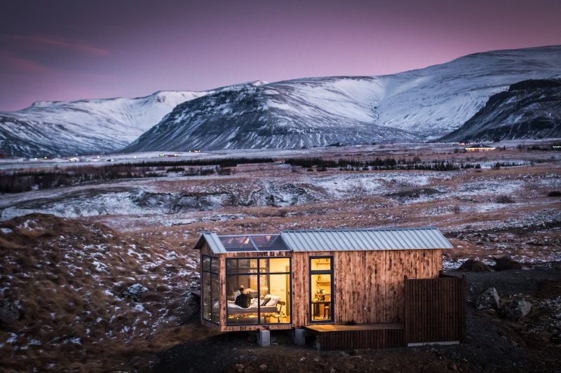 The Panorama Glass Lodge is crafted largely from wood, but at one end floor-to-ceiling windows open it up to the surroundings