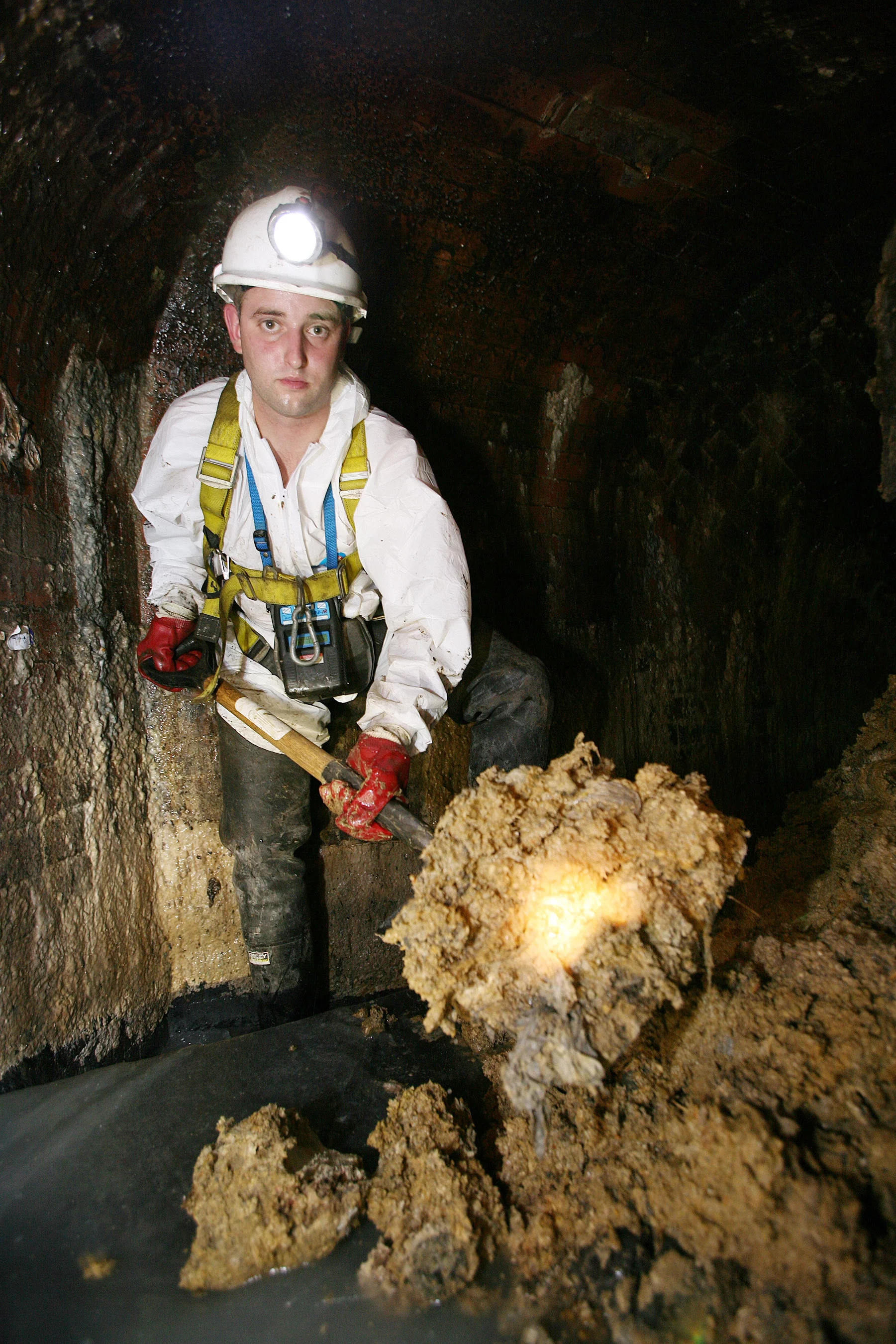 A Thames Water employee clearing fat from beneath London's Leicester Square