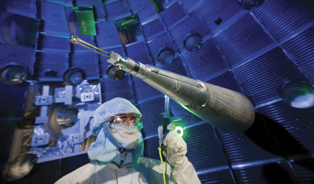 A NIF technician checks the target positioner, which precisely centers the target inside the target chamber (Image: NIF)