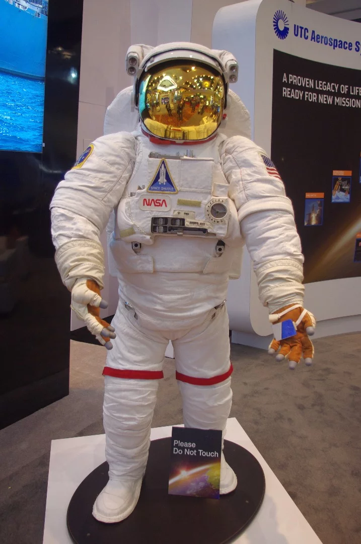 The Extravehicular Mobility Unit from UTC Aerospace Systems. "We use 18,000 parts to protect astronauts from the harsh environment of space, including a puncture-resistant outer layer to protect from micrometeroids traveling at 17,000 miles per hour," says the company. "To control temperature fluctuations ranging from -250 degrees F to +250 degrees F every 90 minutes, we provide a liquid cooling and ventilation garment under the suit that consists of 300 feet of thin tubing that circulates cooling water around the body."