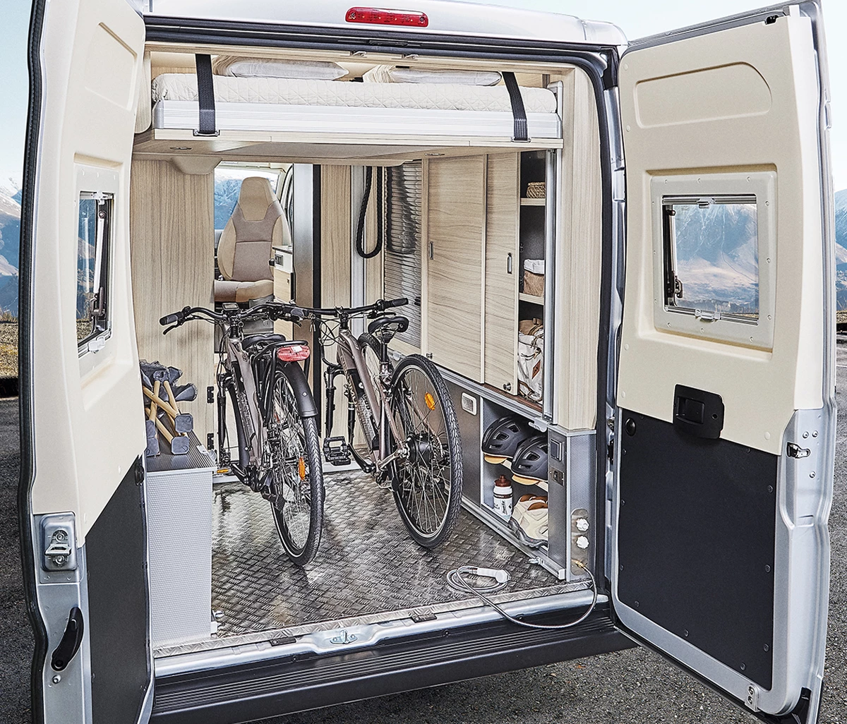 The lower bed removes and the upper bed lifts electrically to clear out a full garage for bikes and other gear