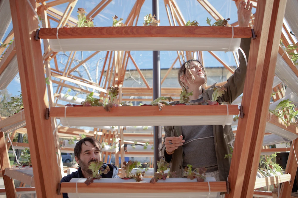 The Jellyfish Barge comprises a glass greenhouse supported by a wooden base (Photo: Matteo de Mayda)