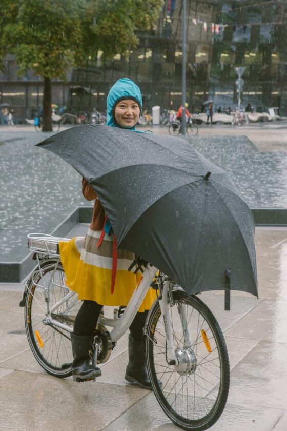 The user's head goes up through a collar tube built into the umbrella, and into an integrated waterproof hood
