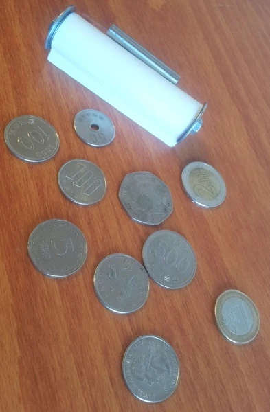 When it's stored away, the Qii keyboard is about as big as a roll of coins, but can be pulled out easily like a tape measure and laid over almost any surface to type on