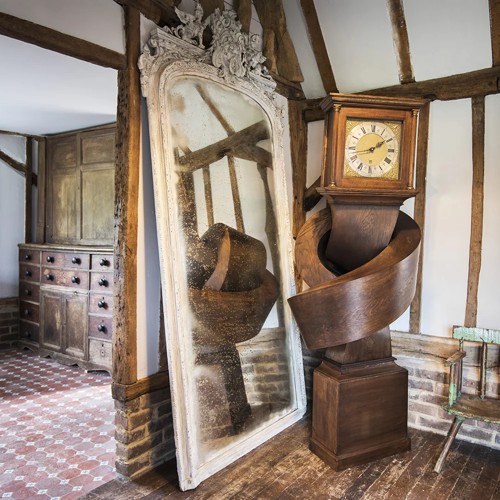 Growing up gets me down contorts a grandfather clock into an unlikely position