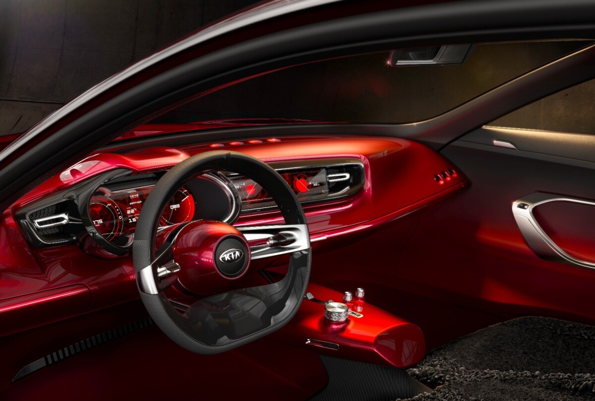 The dashboard, steering column and hovering console serve as an extension of the Lava Red bodywork