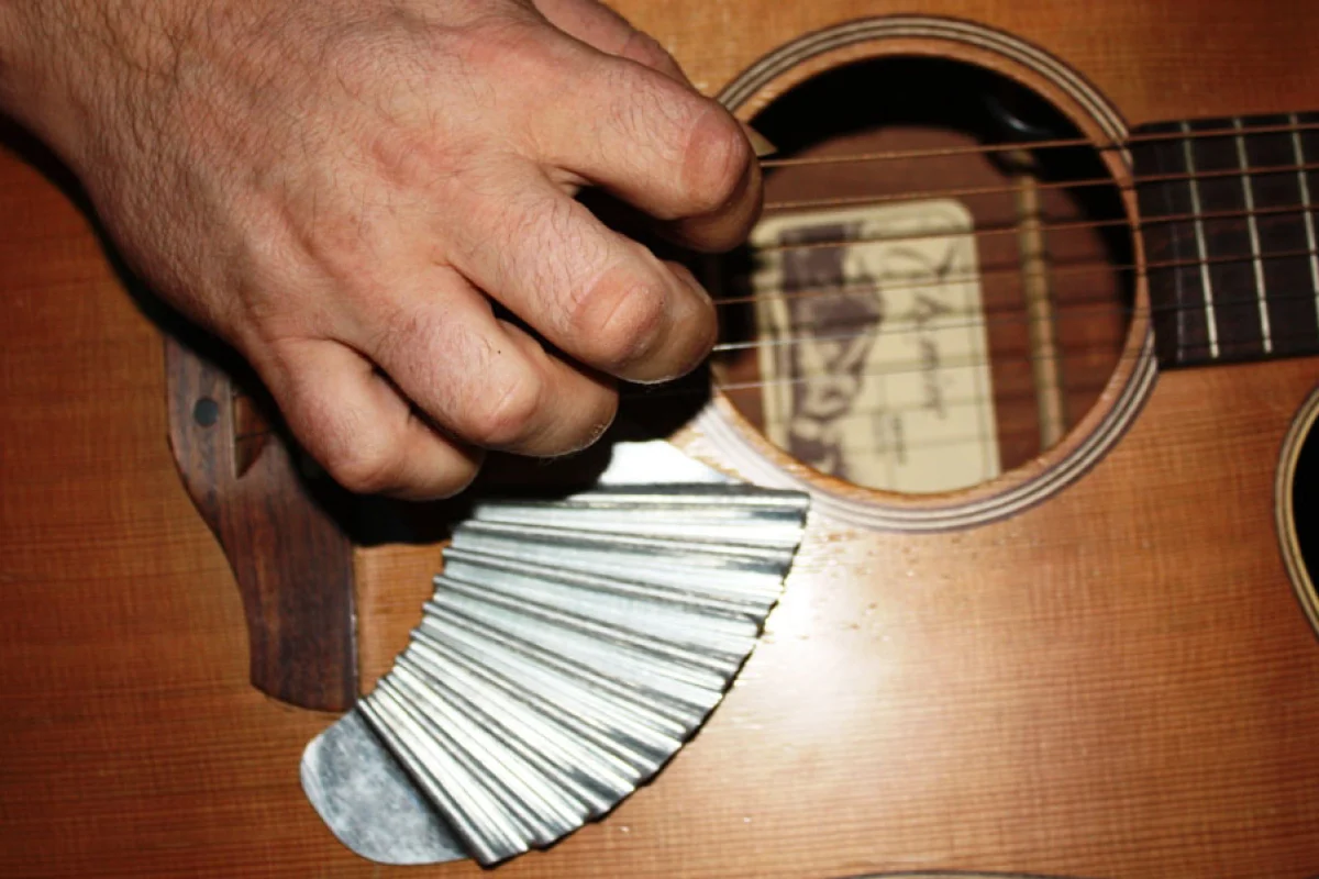 When attached below the picking area of an acoustic guitar, the Pik'N Board offers players the means to provide their own strum-stroke back beat