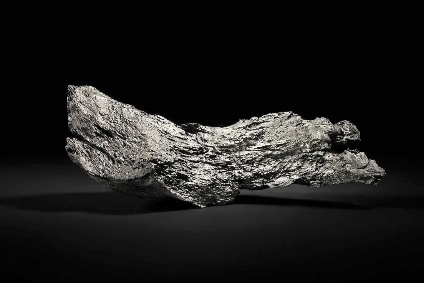This 19.7kg Dronino Meteorite comes from the Ryazan district of Russia, and displays the wavy, textured, surface that is unique to Dronino meteorites, resulting from the centuries-long interaction of this meteorite’s unique chemical composition with that of the ground. Unmounted, the meteorite balances stably on a flat surface and measures 17 x 7 x 61⁄4 inches (43.5 x 18 x 16 cm)