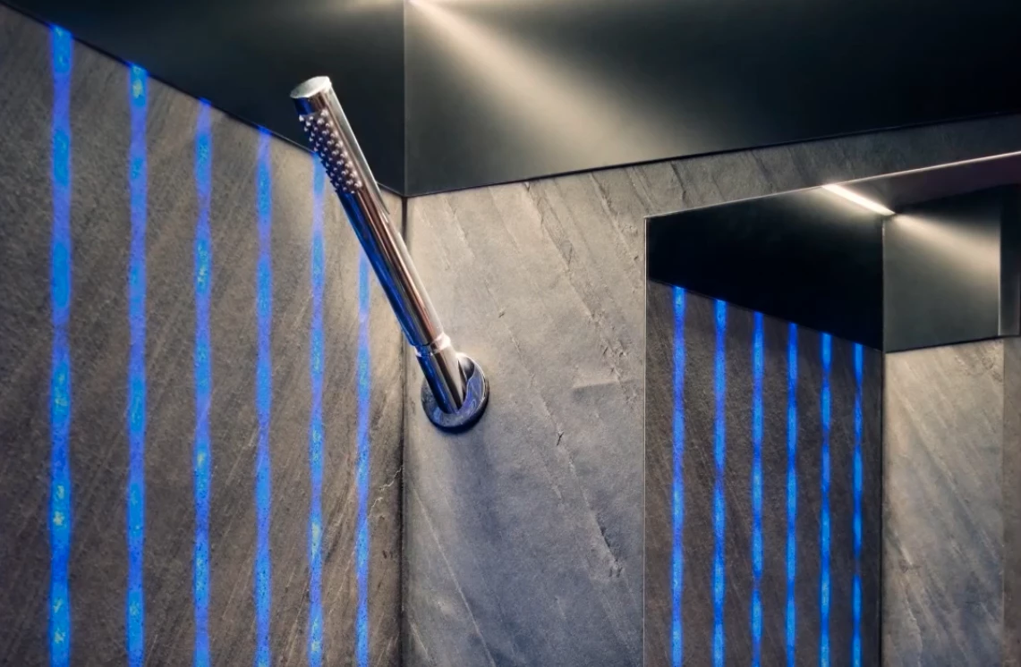 Real stone walls combine with an integrated selectable lighting system and rainfall shower to offer a wet bath like no other