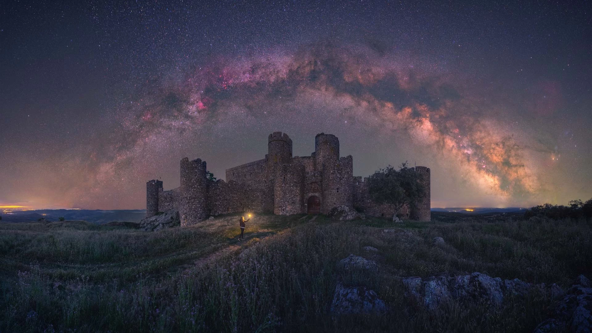 Path To The Past. The galactic core stretches above a 15th-century castle in Extremadura, Spain